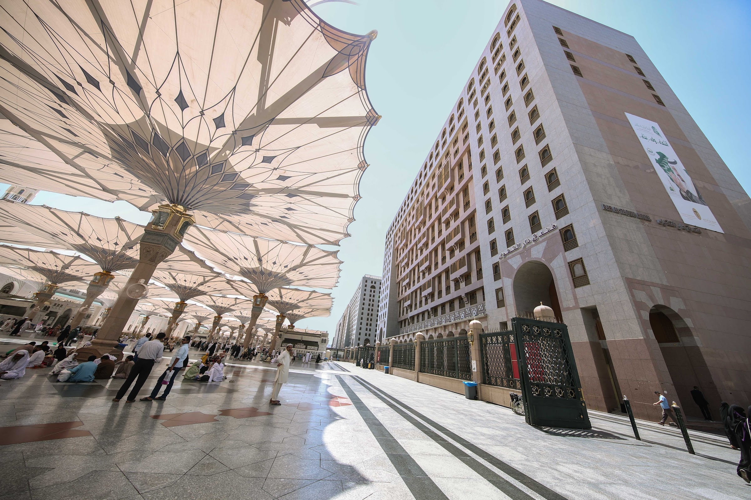 The hotel beside the umbrellas of the Prophet's Mosque courtyard