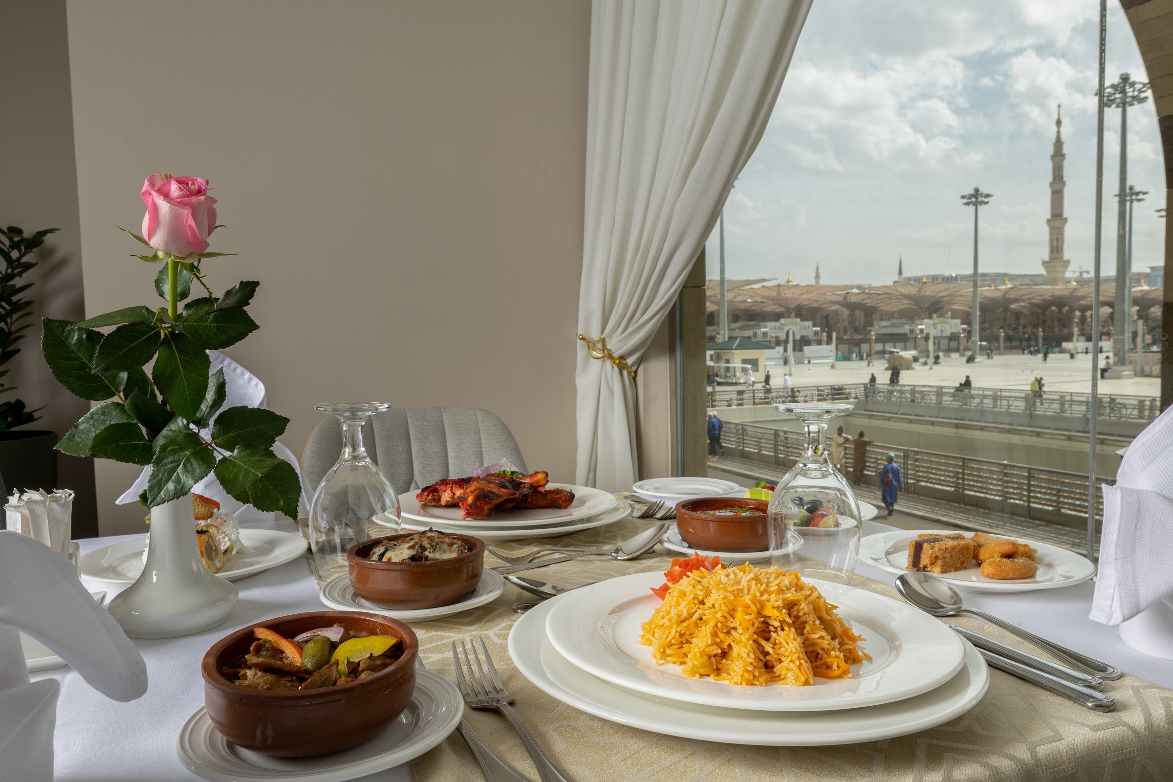 A table by a window looking toward the Prophet's Mosque
