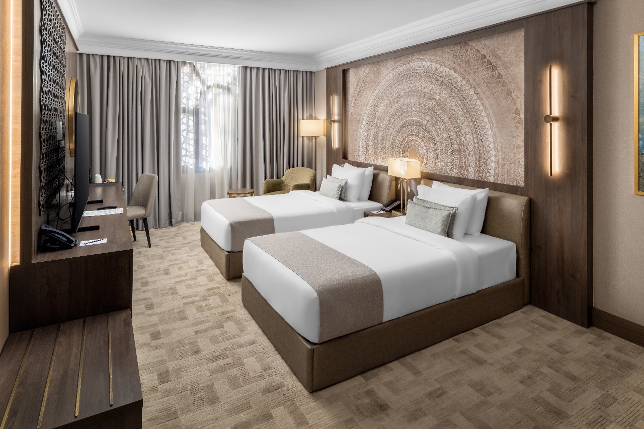 A room with two single beds