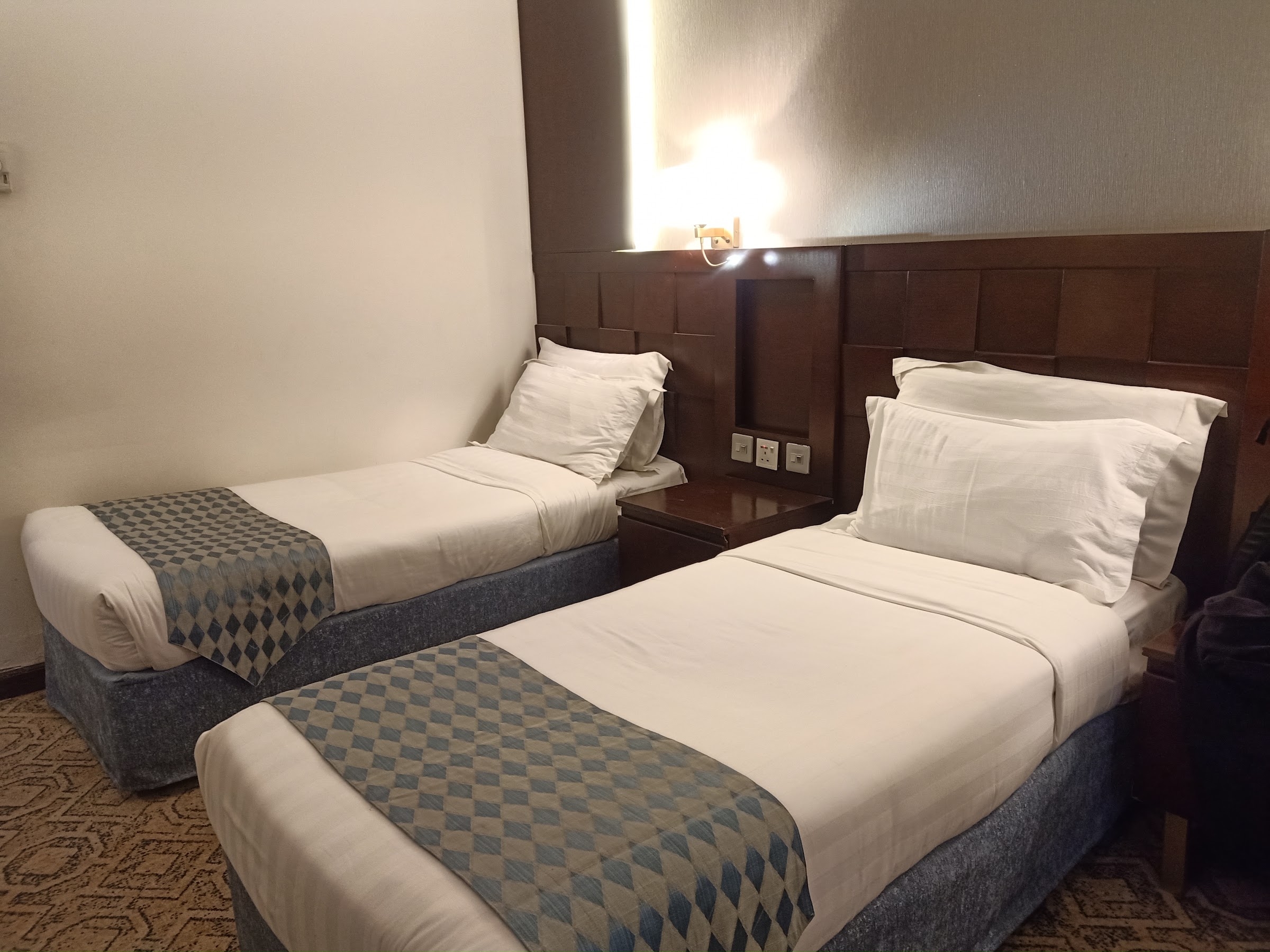 A room with two single beds