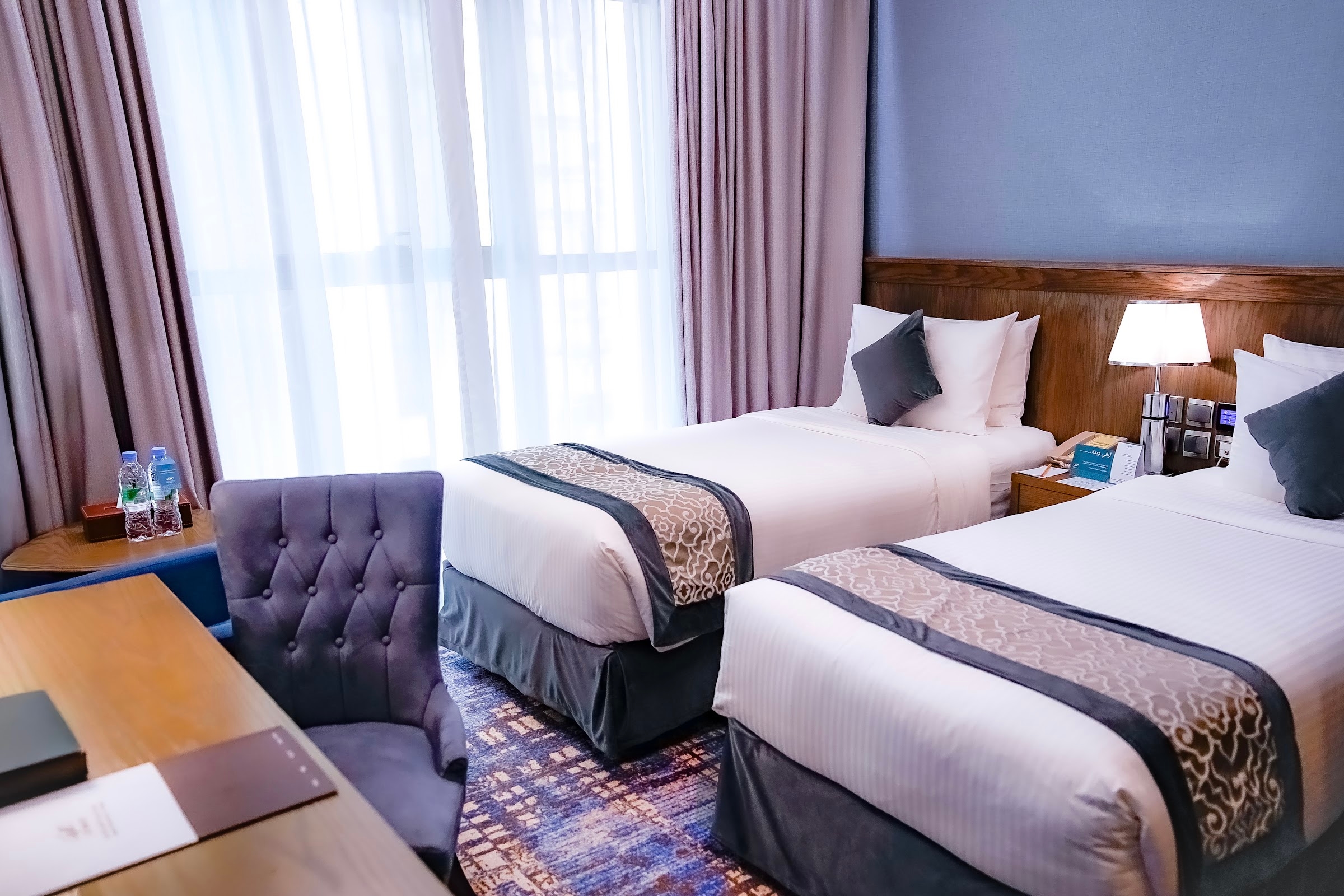 A room with two single beds